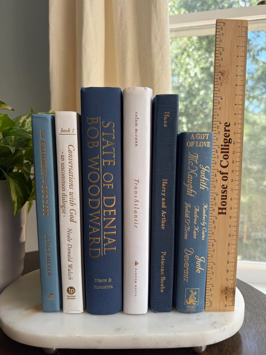 Curated collection of layered blue books ranging from pale coastal blue to deeper ocean tones.