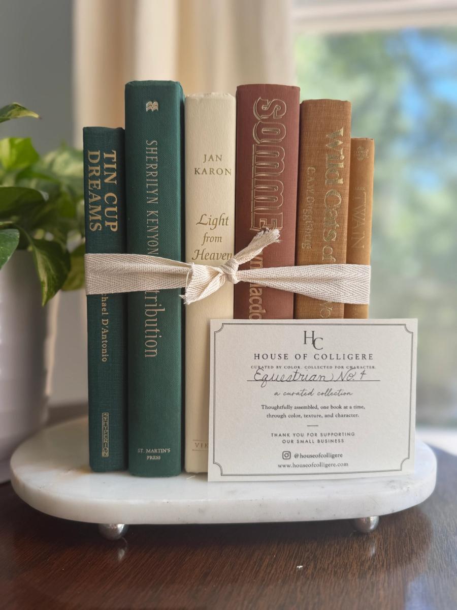 Curated collection of rich brown, hunter green, deep navy, and warm ivory books with classic gold accents.