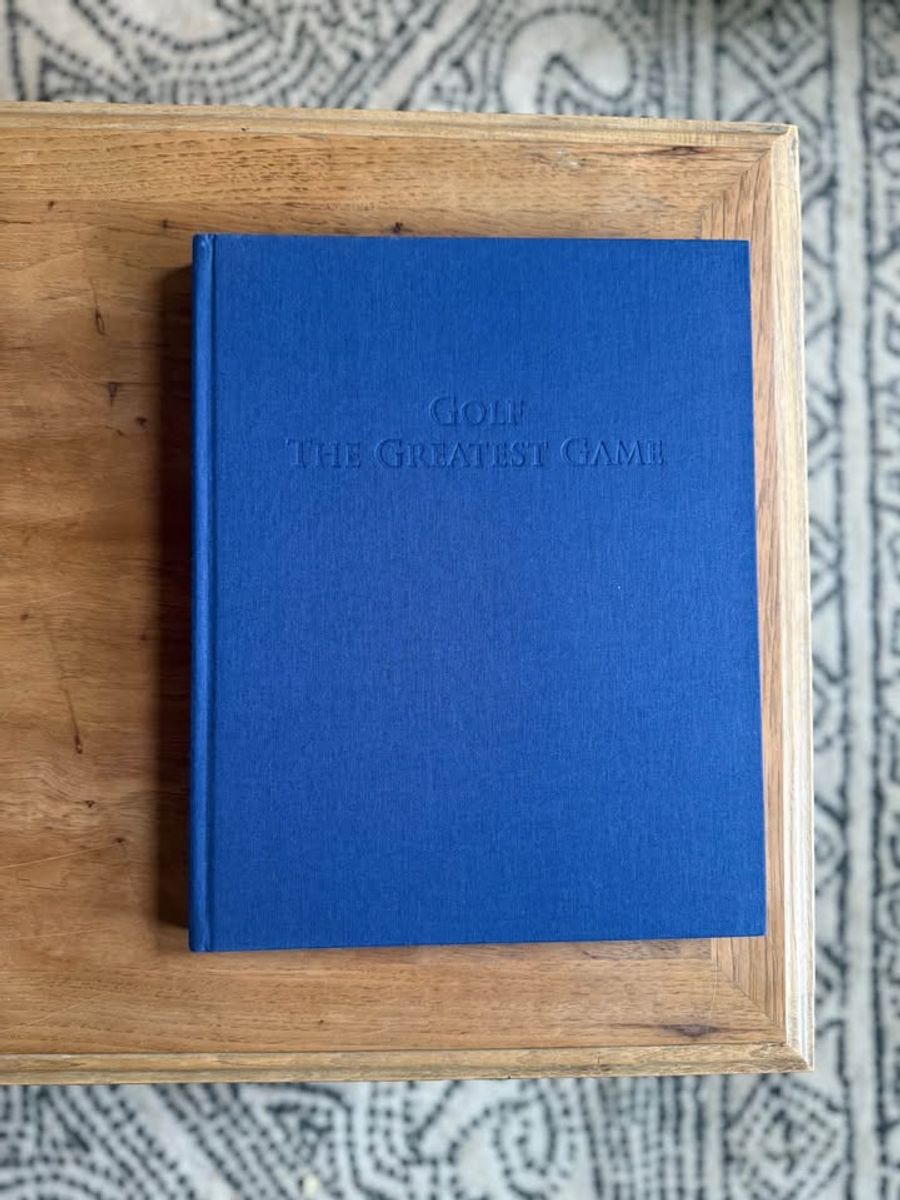 Coffee Table Design, Blue, Navy, Sky, linen-like cloth covers, matte woven texture, subtle gold and metallic lettering, understated traditional styling