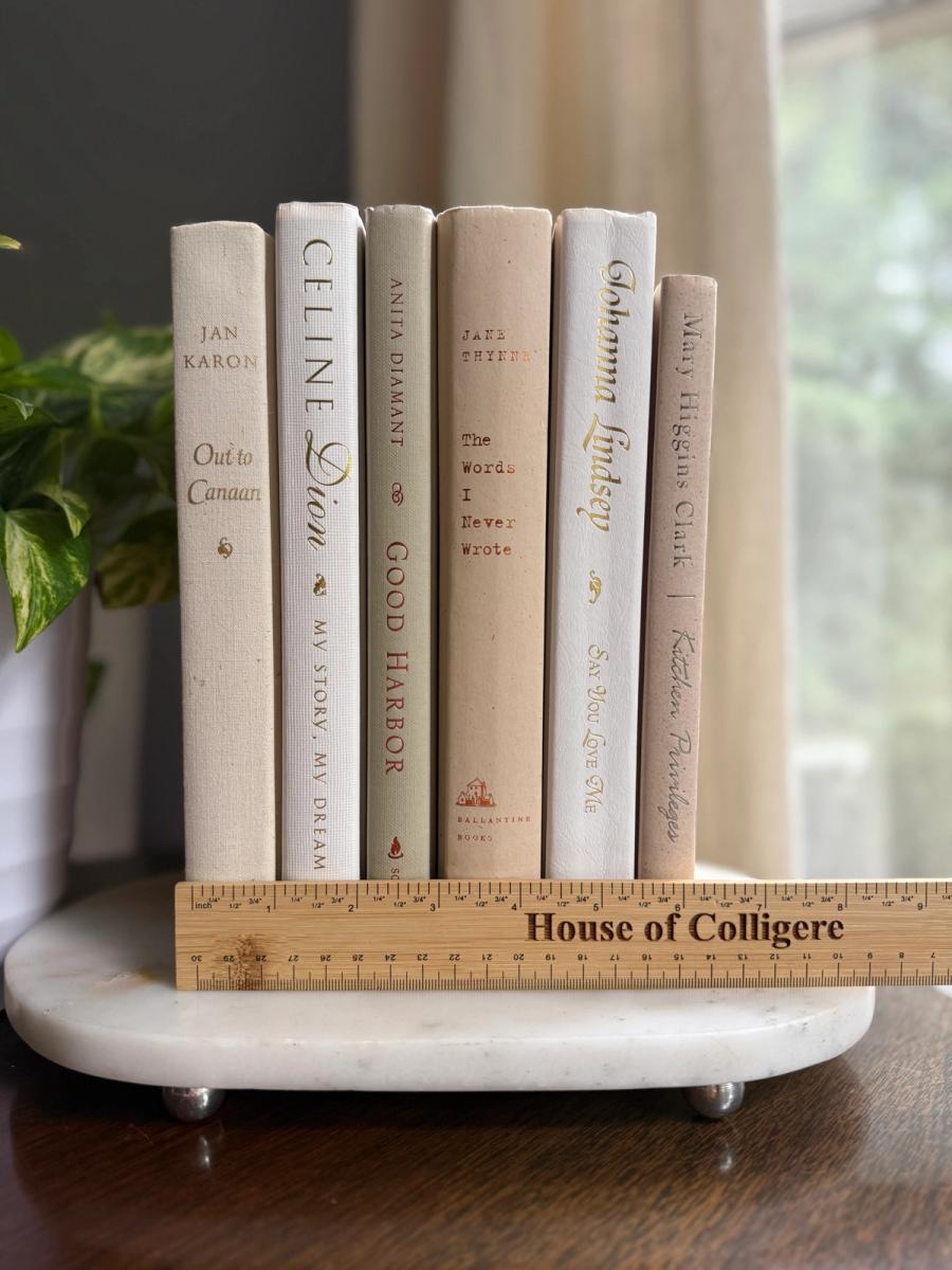 Curated collection of crisp white, ivory, and warm cream books with soft neutral tones.