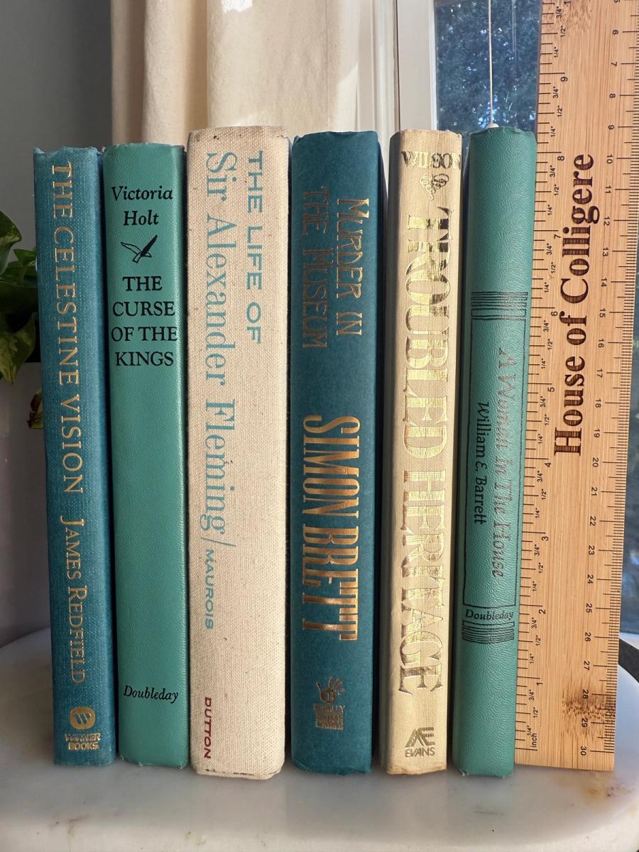 Curated collection of white, pale blue, sand, and soft coastal-neutral books with an airy, sun-faded look.