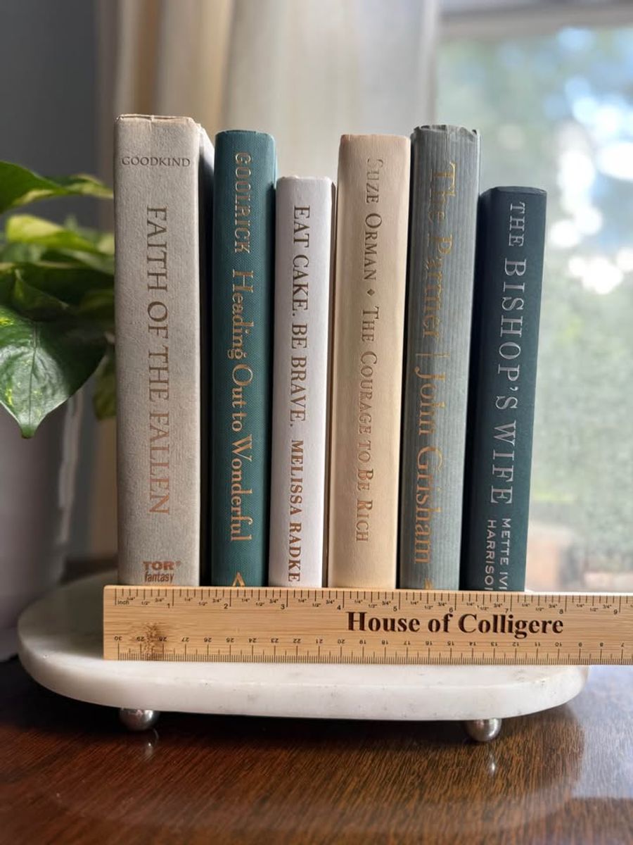 Curated collection of white, pale blue, sand, and soft coastal-neutral books with an airy, sun-faded look.