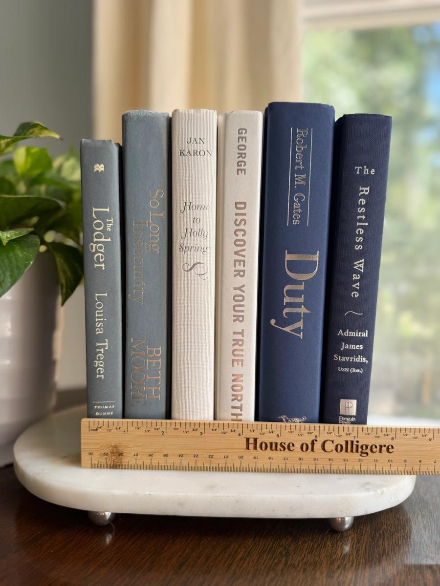 Curated collection of layered blue books ranging from pale coastal blue to deeper ocean tones.