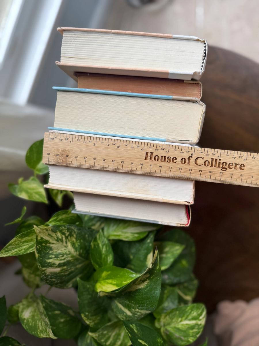 Curated decorative book collection in soft linen-inspired neutrals, featuring ivory, cream, warm beige, and pale taupe clothbound hardcovers with subtle gold, brown, and muted typography.