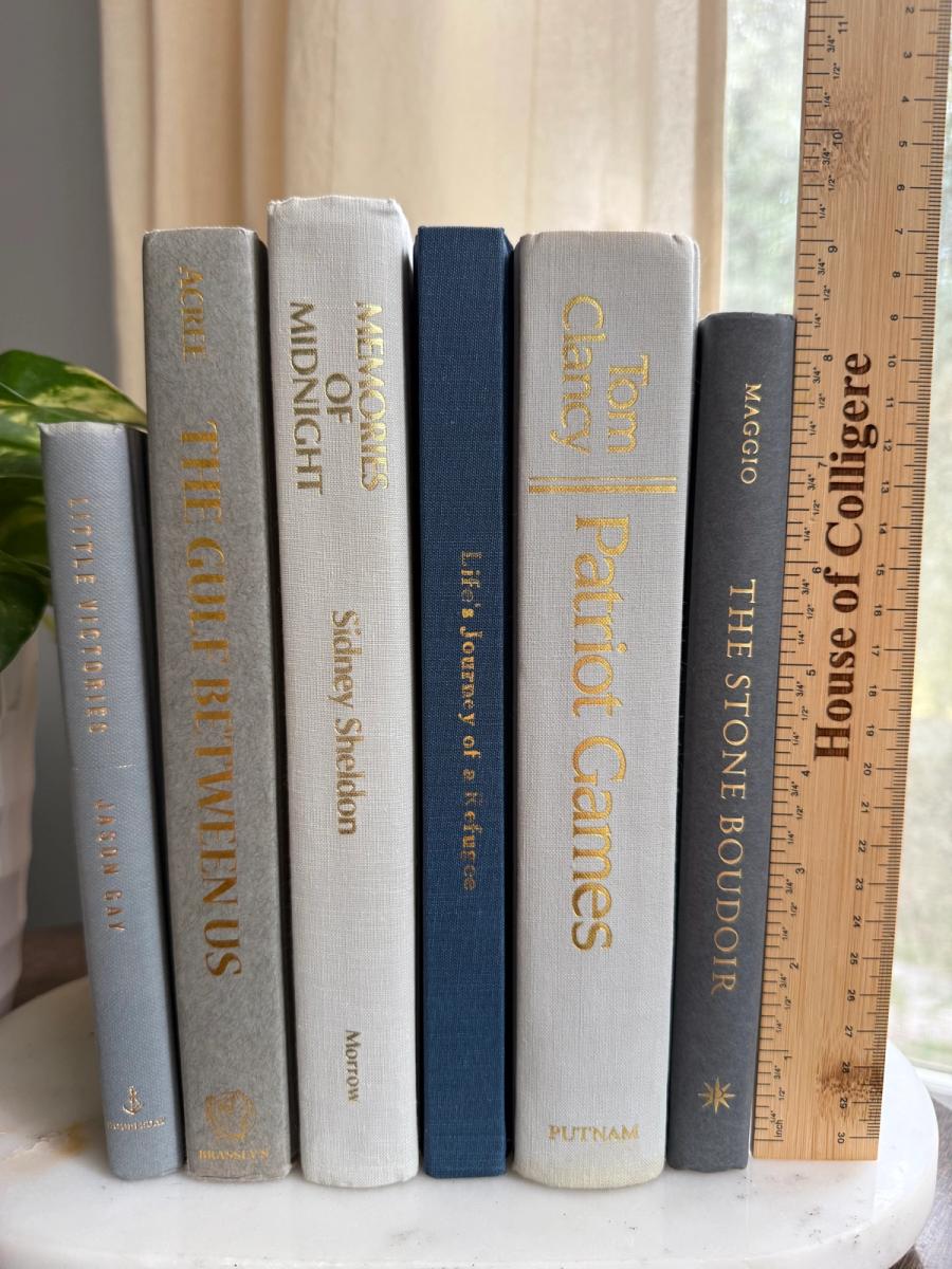 Curated collection of muted blue-gray, slate, charcoal, and softly weathered neutral books.