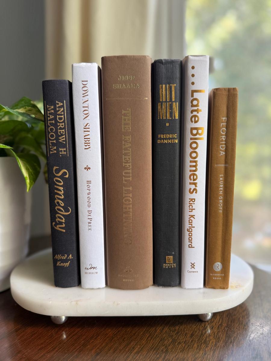 Curated collection of warm brown, olive, tan, and aged neutral books with a traditional library palette.