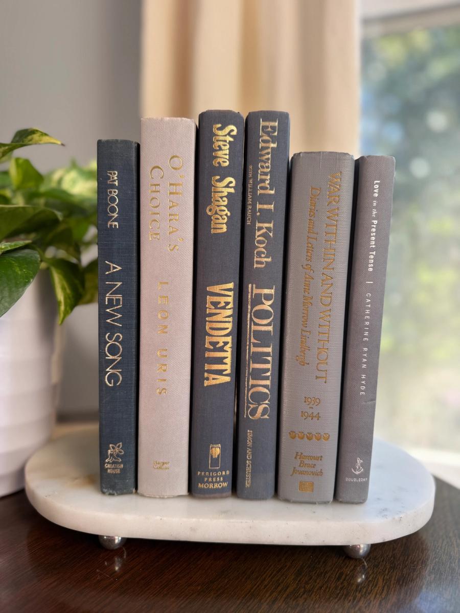 Curated collection of muted blue-gray, slate, charcoal, and softly weathered neutral books.