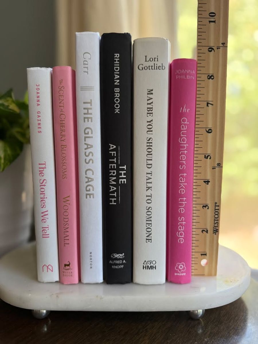 Modernist Edit No. 10 decorative book collection in white, blush pink, black, and raspberry tones, tied with neutral linen ribbon and styled on a marble table.