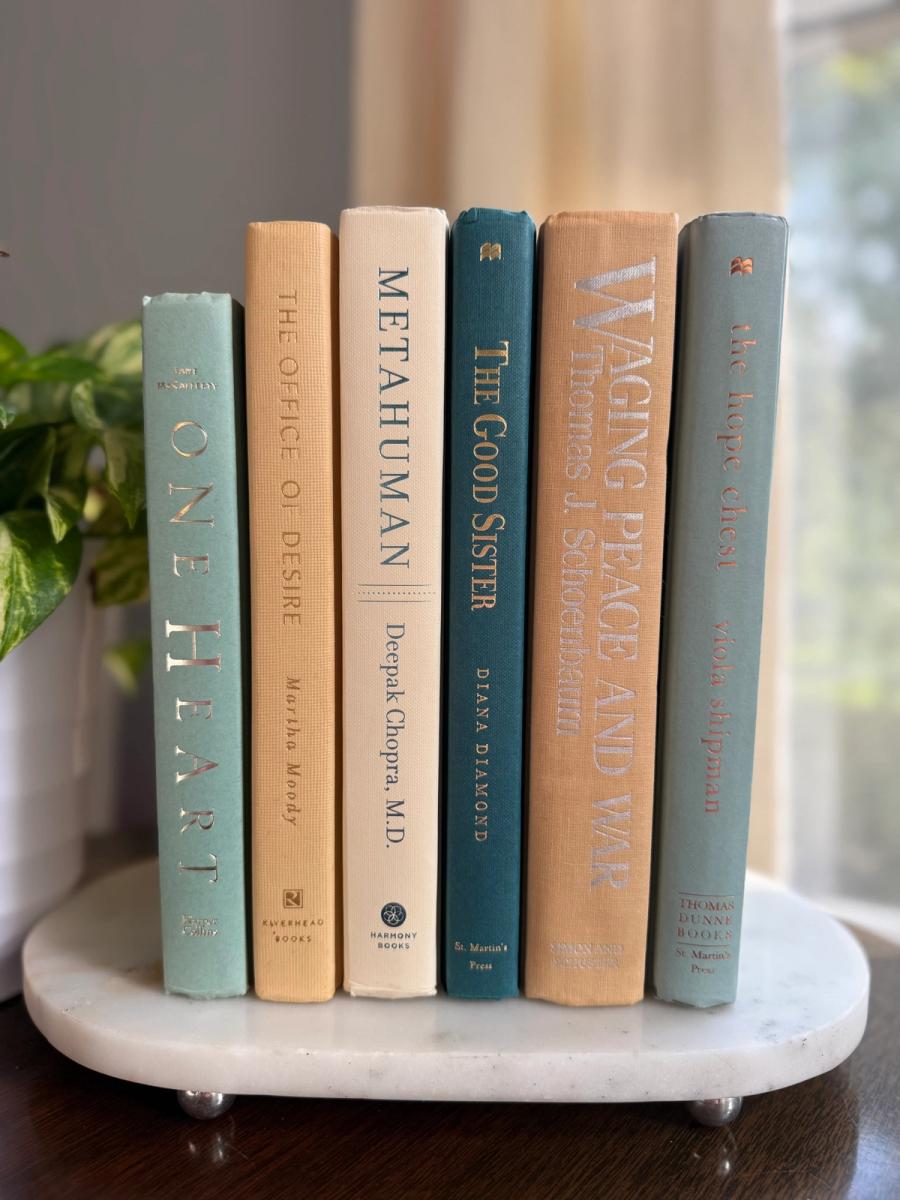 Curated collection of white, pale blue, sand, and soft coastal-neutral books with an airy, sun-faded look.