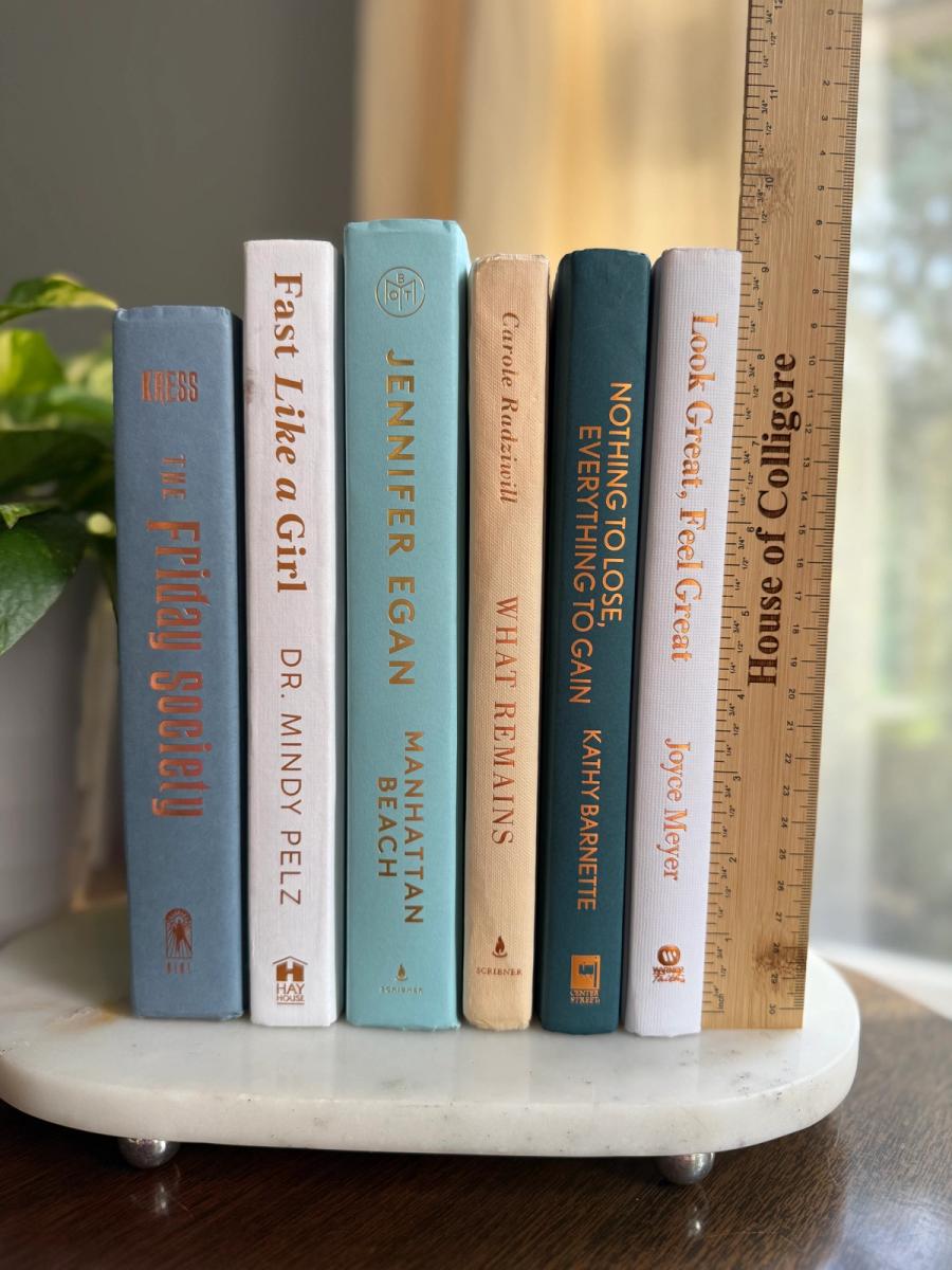Curated collection of white, pale blue, sand, and soft coastal-neutral books with an airy, sun-faded look.