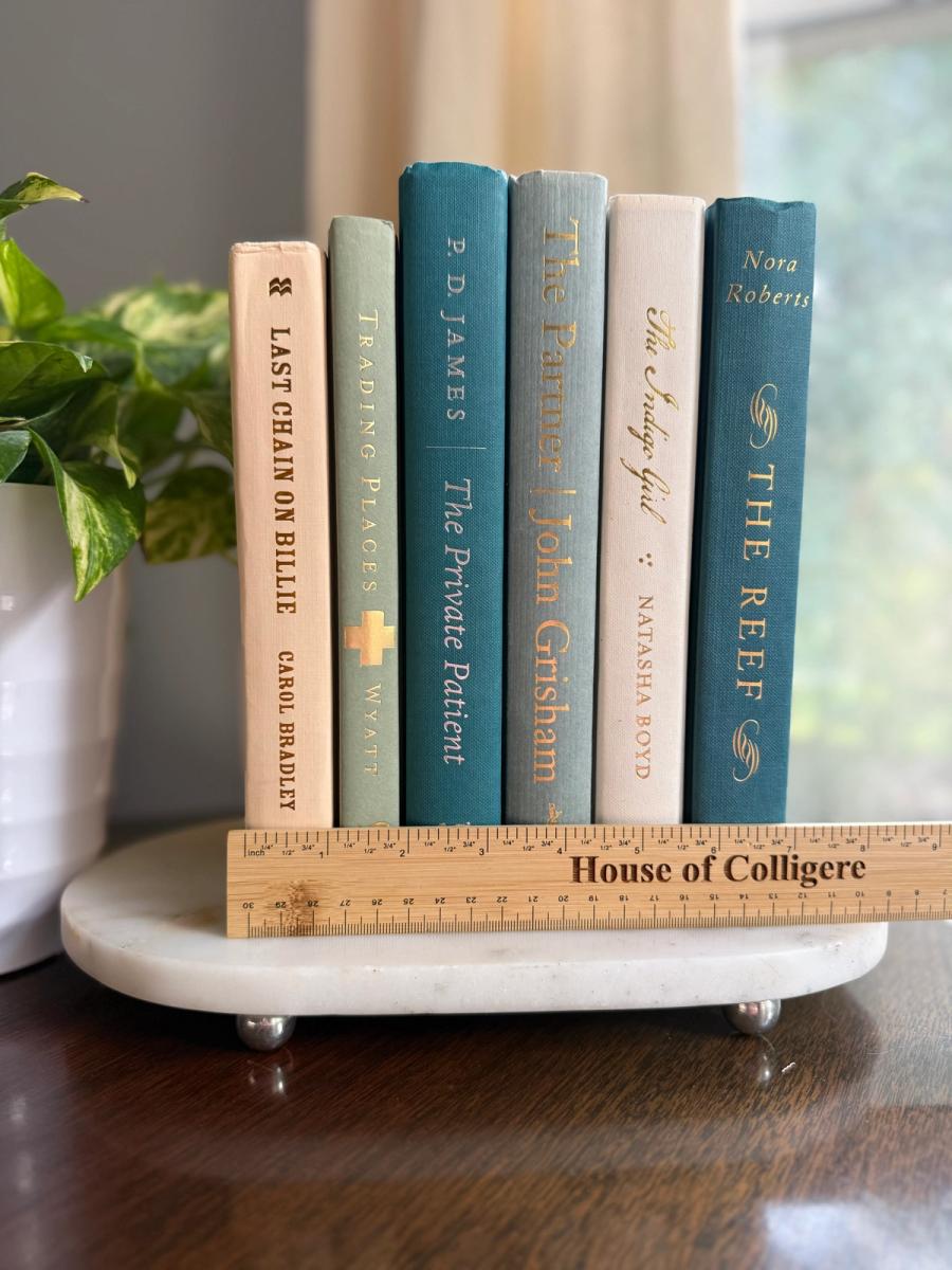 Curated collection of white, pale blue, sand, and soft coastal-neutral books with an airy, sun-faded look.