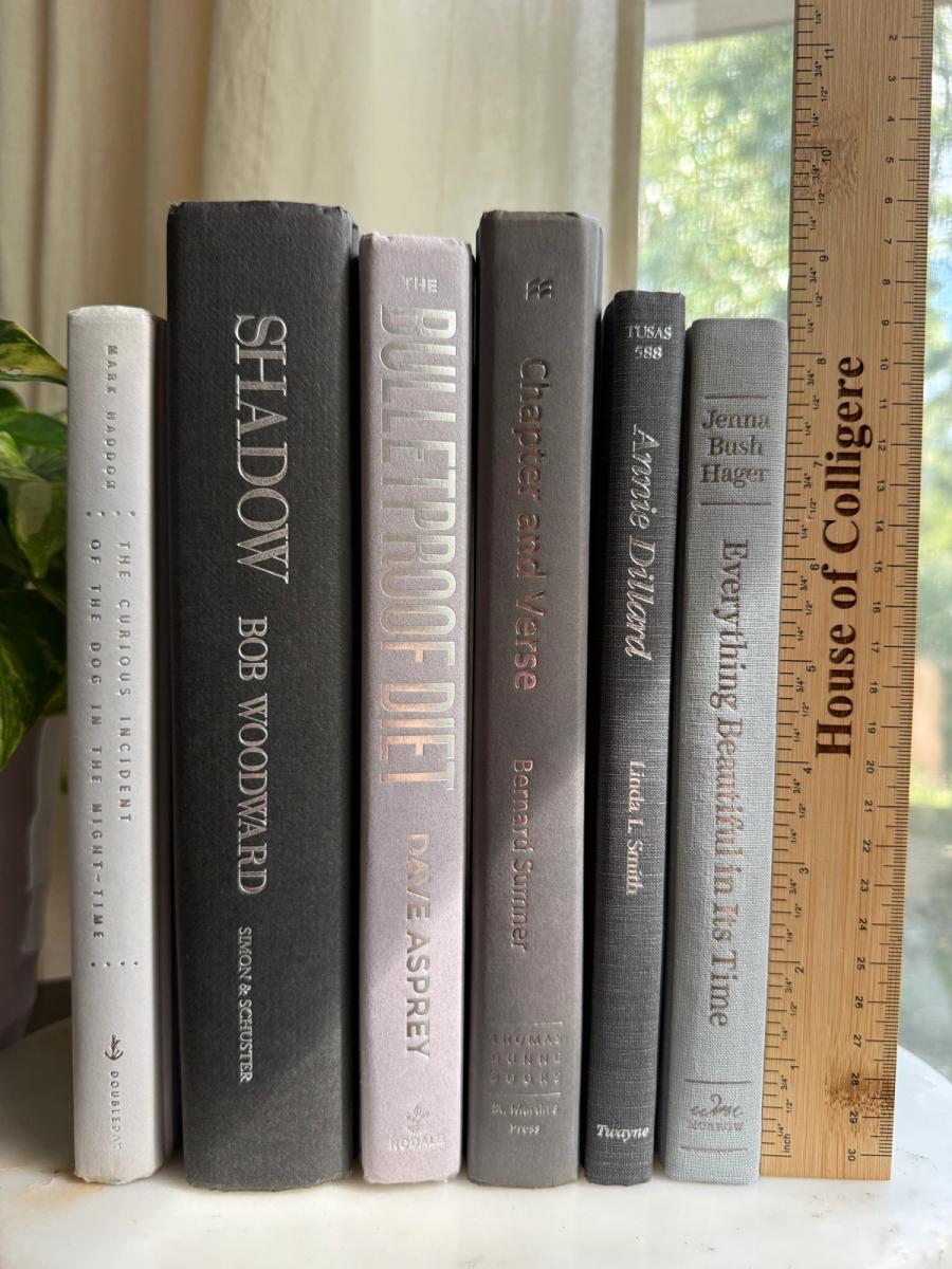Curated collection of soft white, pale gray, warm greige, and stone-toned books with subtle tonal variation.