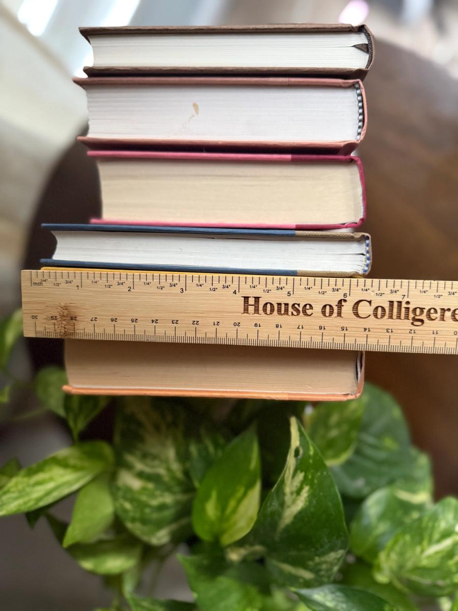 Curated collection of dusty rose, plum, warm brown, taupe, and muted berry-toned books with soft vintage character.