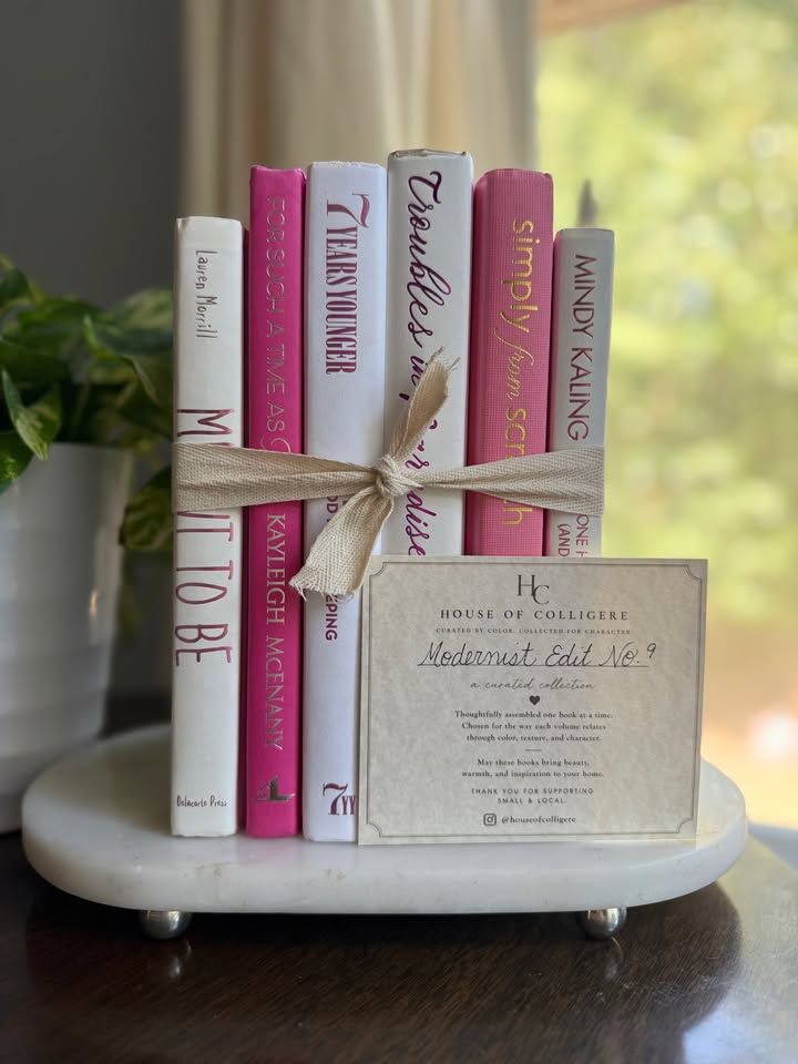 Modernist Edit No. 9 decorative book collection in vivid pink, white, and soft blush tones, tied with neutral linen ribbon and styled on a marble table.