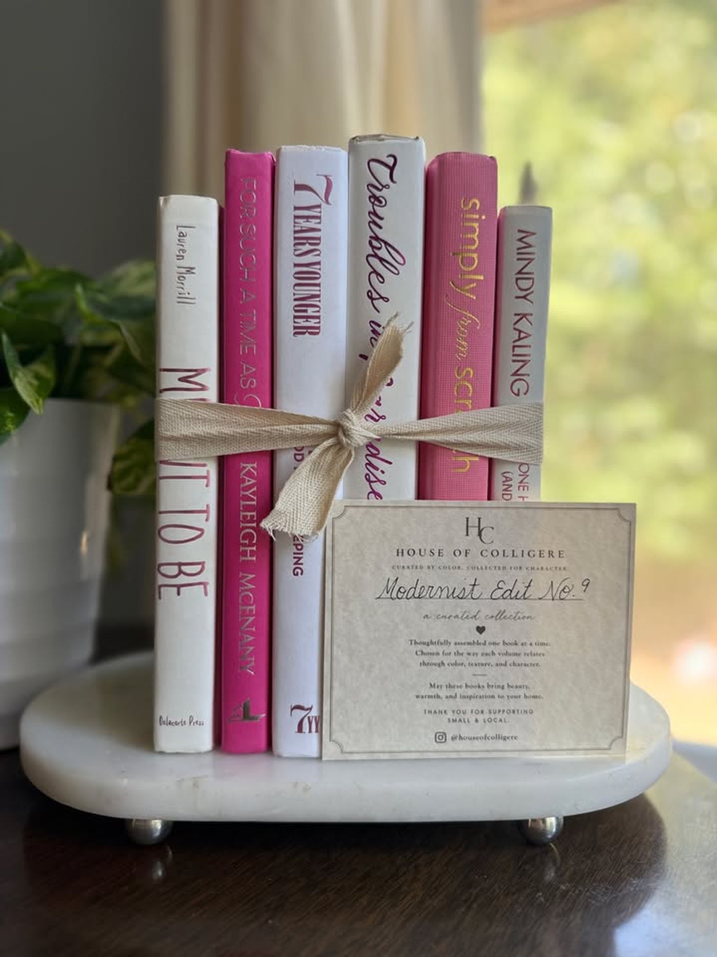 Modernist Edit No. 9 decorative book collection in vivid pink, white, and soft blush tones, tied with neutral linen ribbon and styled on a marble table.