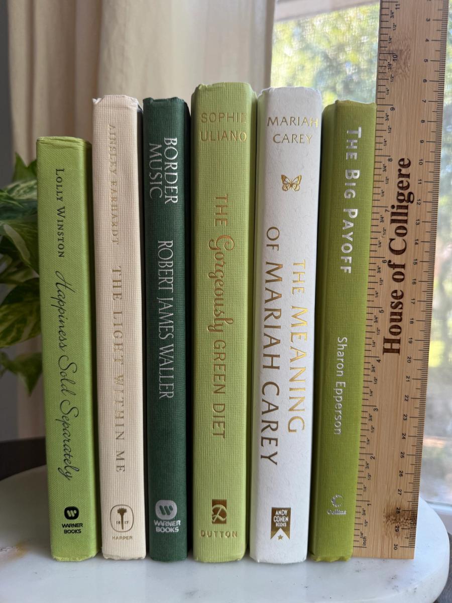 Curated collection of soft sage, olive, cream, and muted green books with botanical tones.