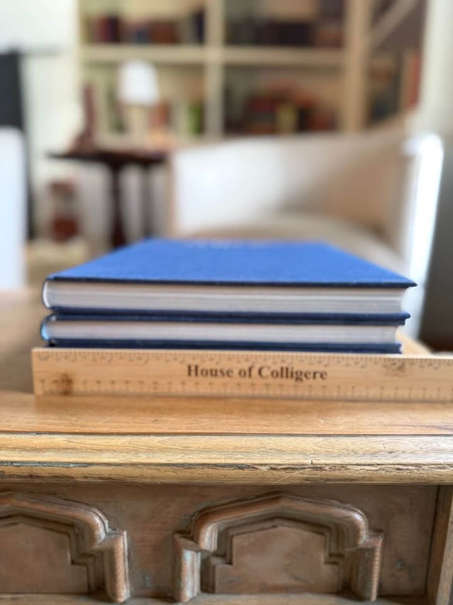 Blue, linen-like cloth covers, matte woven texture, subtle gold and metallic lettering, understated traditional styling