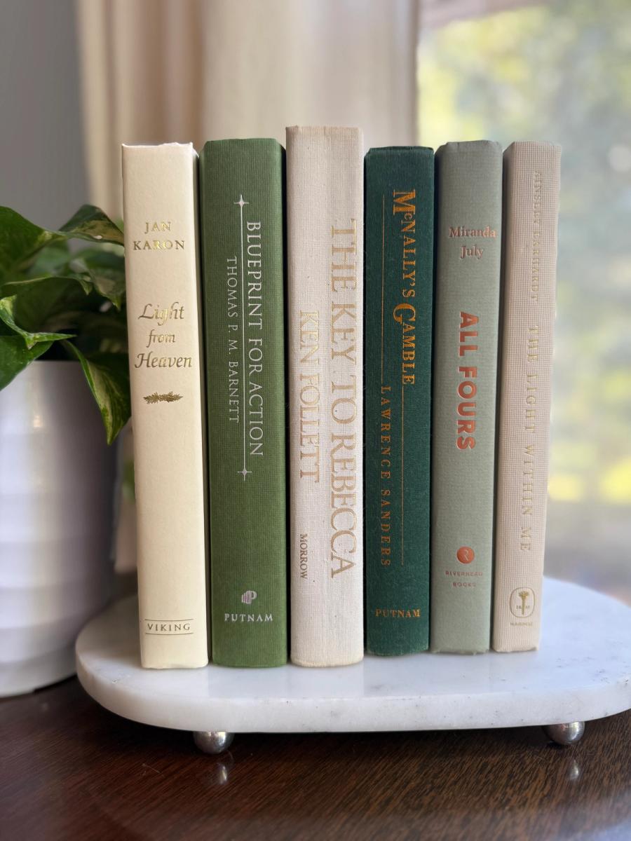 Curated collection of soft sage, olive, cream, and muted green books with botanical tones.