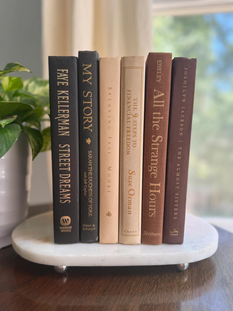 Curated collection of warm brown, olive, tan, and aged neutral books with a traditional library palette.
