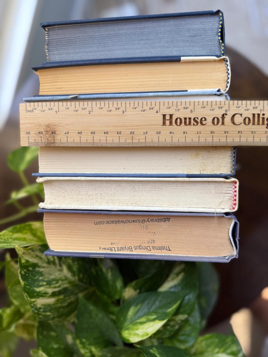 Curated collection of layered blue books ranging from pale coastal blue to deeper ocean tones.