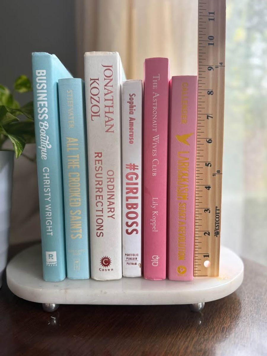 Curated collection of aqua, pale blue, white, and pink books with bright pastel tones and playful contrast.