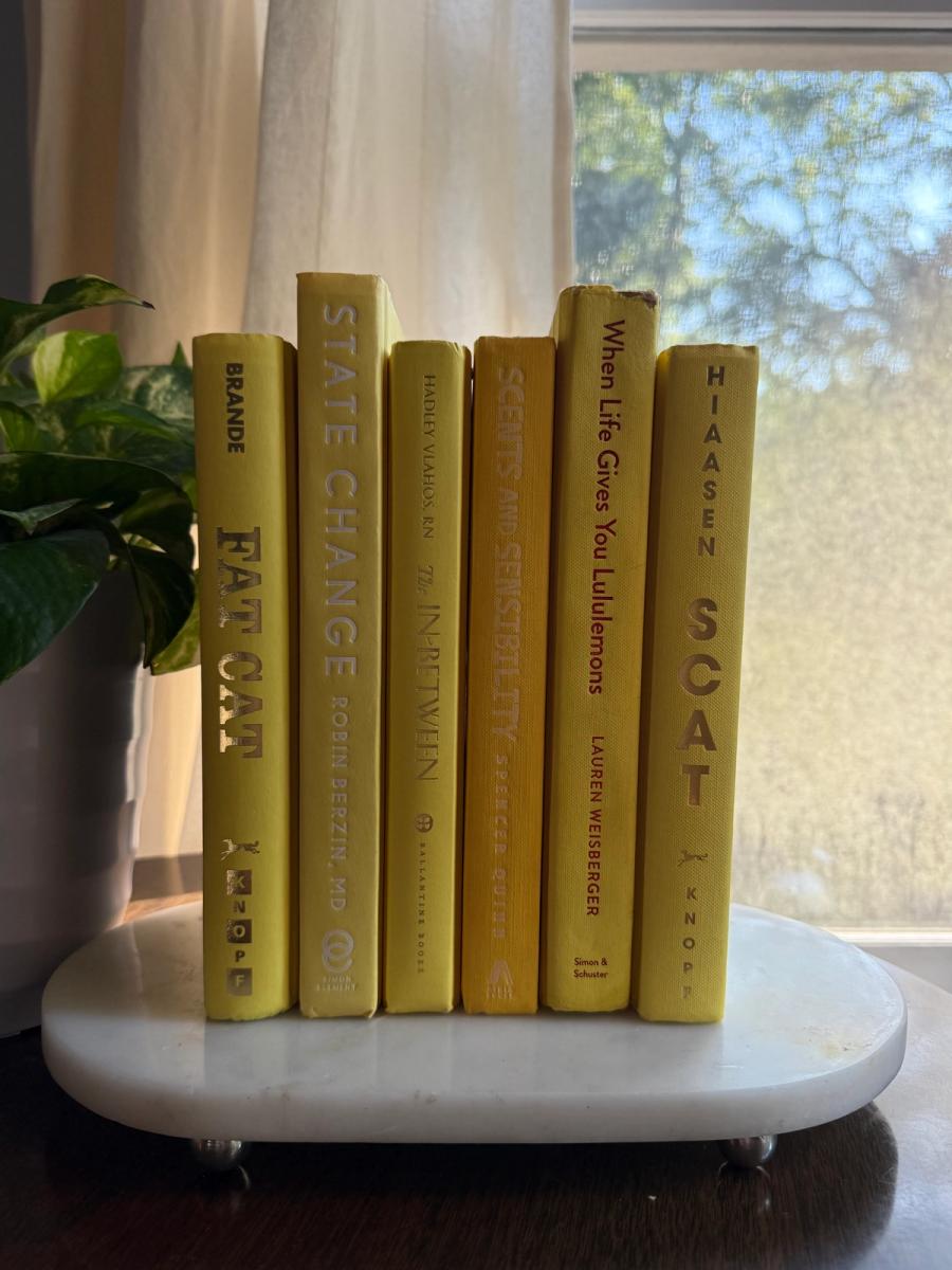 Curated collection of six mustard and golden yellow hardcover books tied with natural cotton ribbon, styled on a marble tray with a House of Colligere Modernist Edit No. 4 collection card.