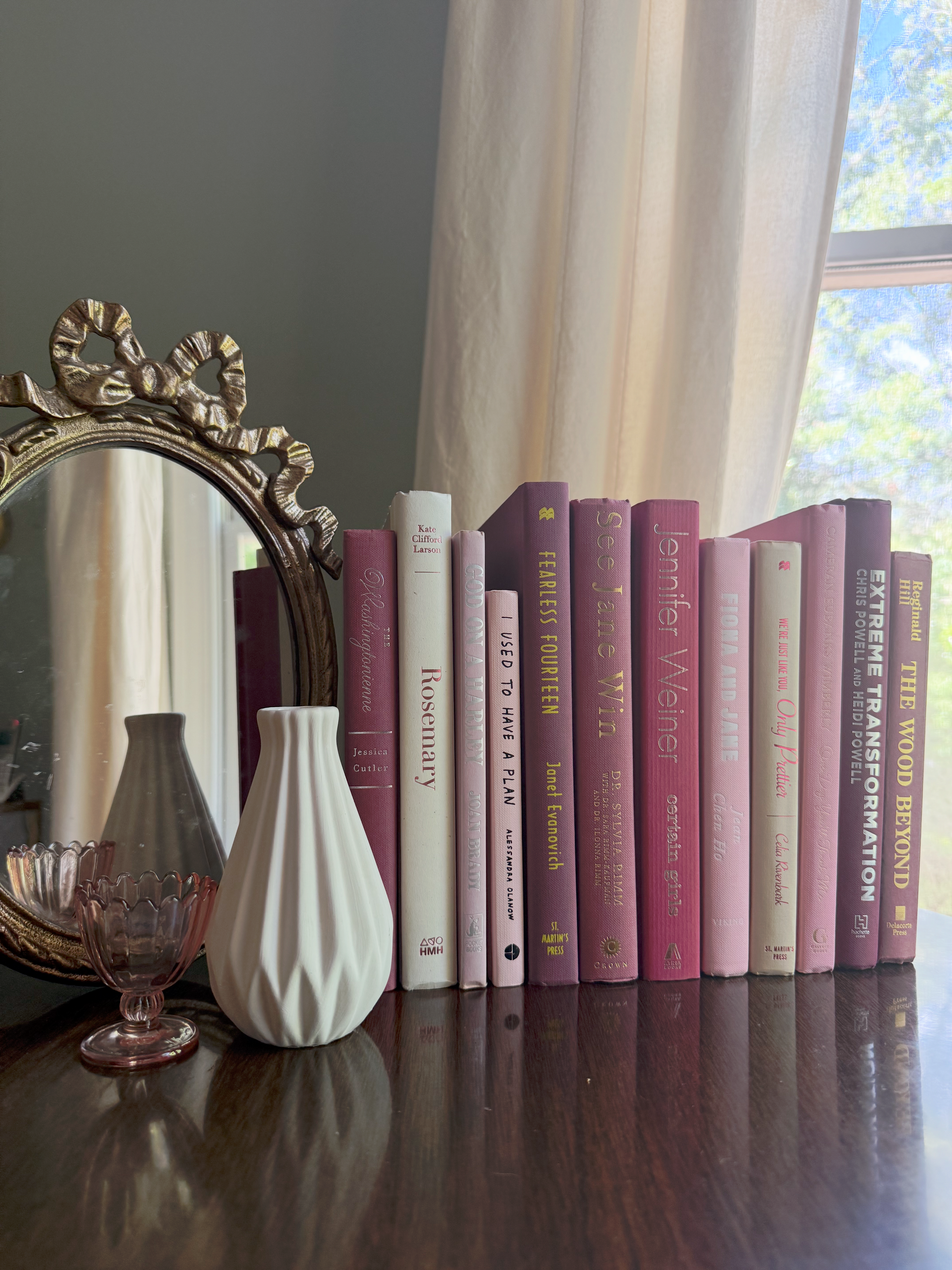 Curated collection of blush, dusty rose, warm taupe, and softly muted neutral books.