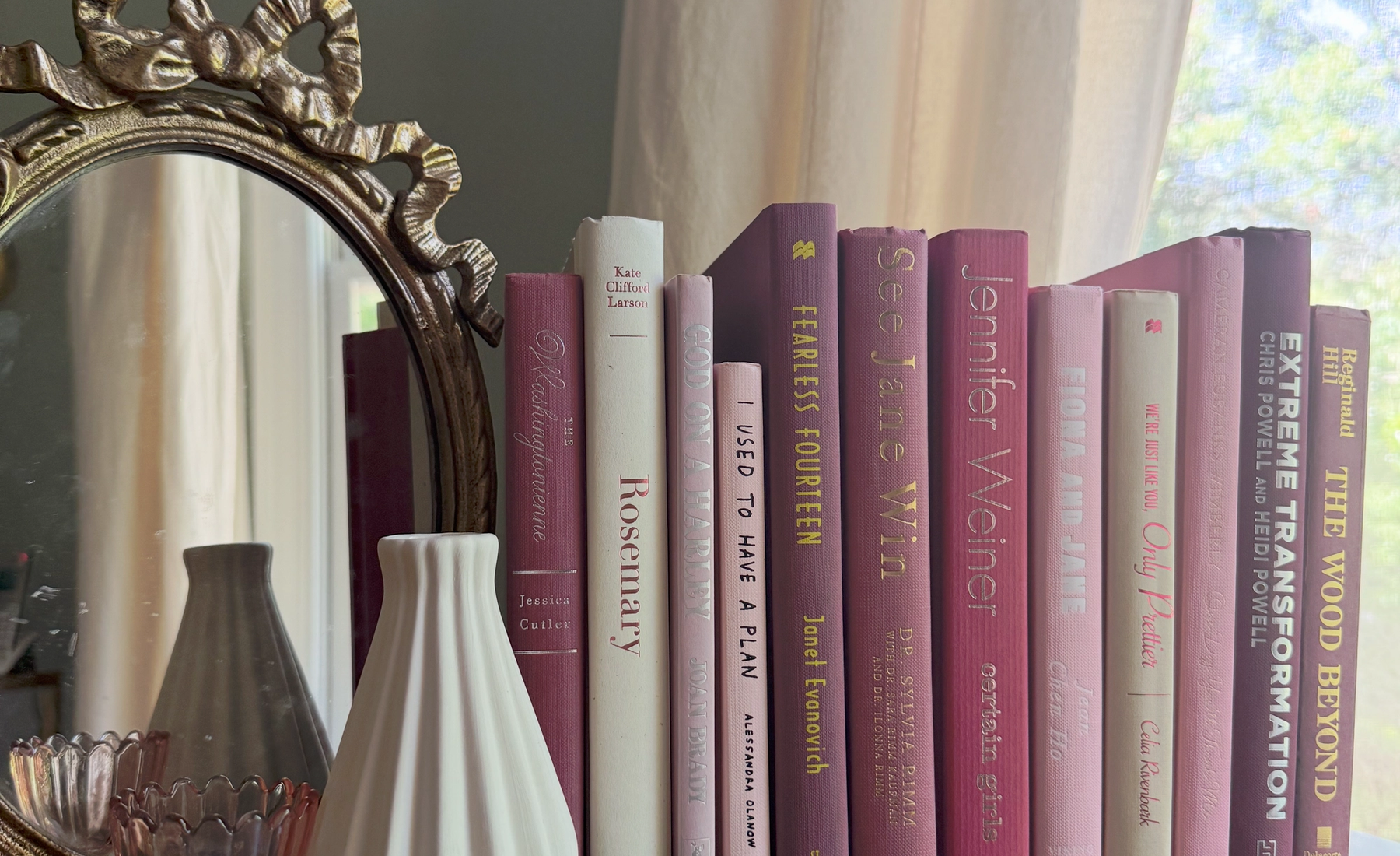 Curated collection of blush, dusty rose, warm taupe, and softly muted neutral books.