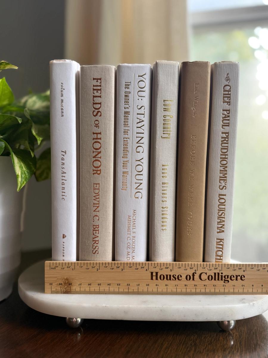 Curated collection of crisp white, ivory, and warm cream books with soft neutral tones.