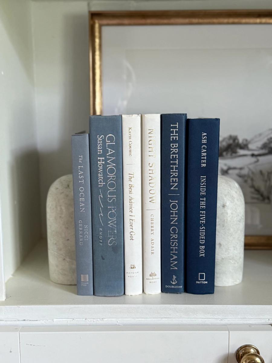 Curated collection of layered blue books ranging from pale coastal blue to deeper ocean tones.