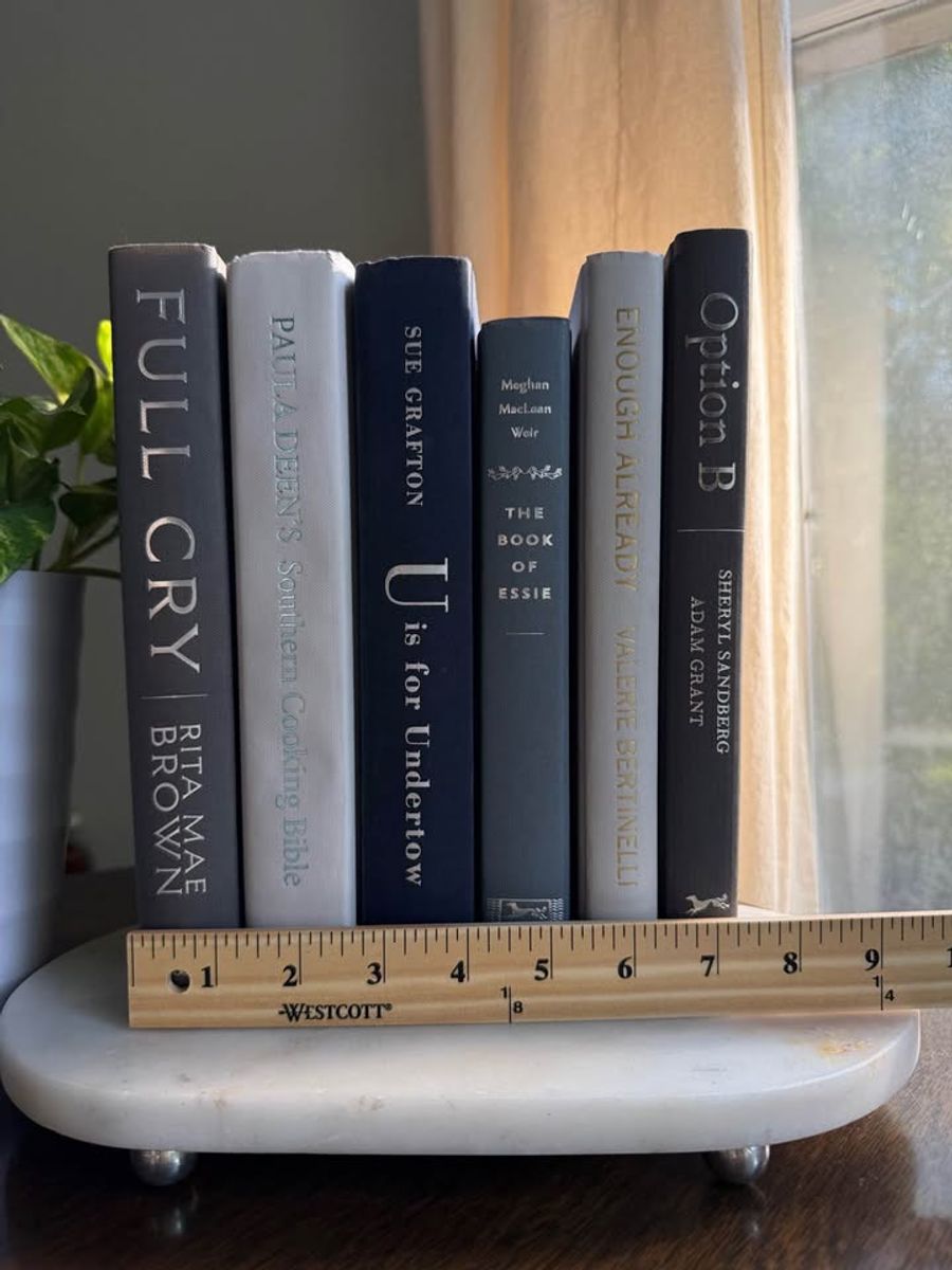 Curated collection of muted blue-gray, slate, charcoal, and softly weathered neutral books.
