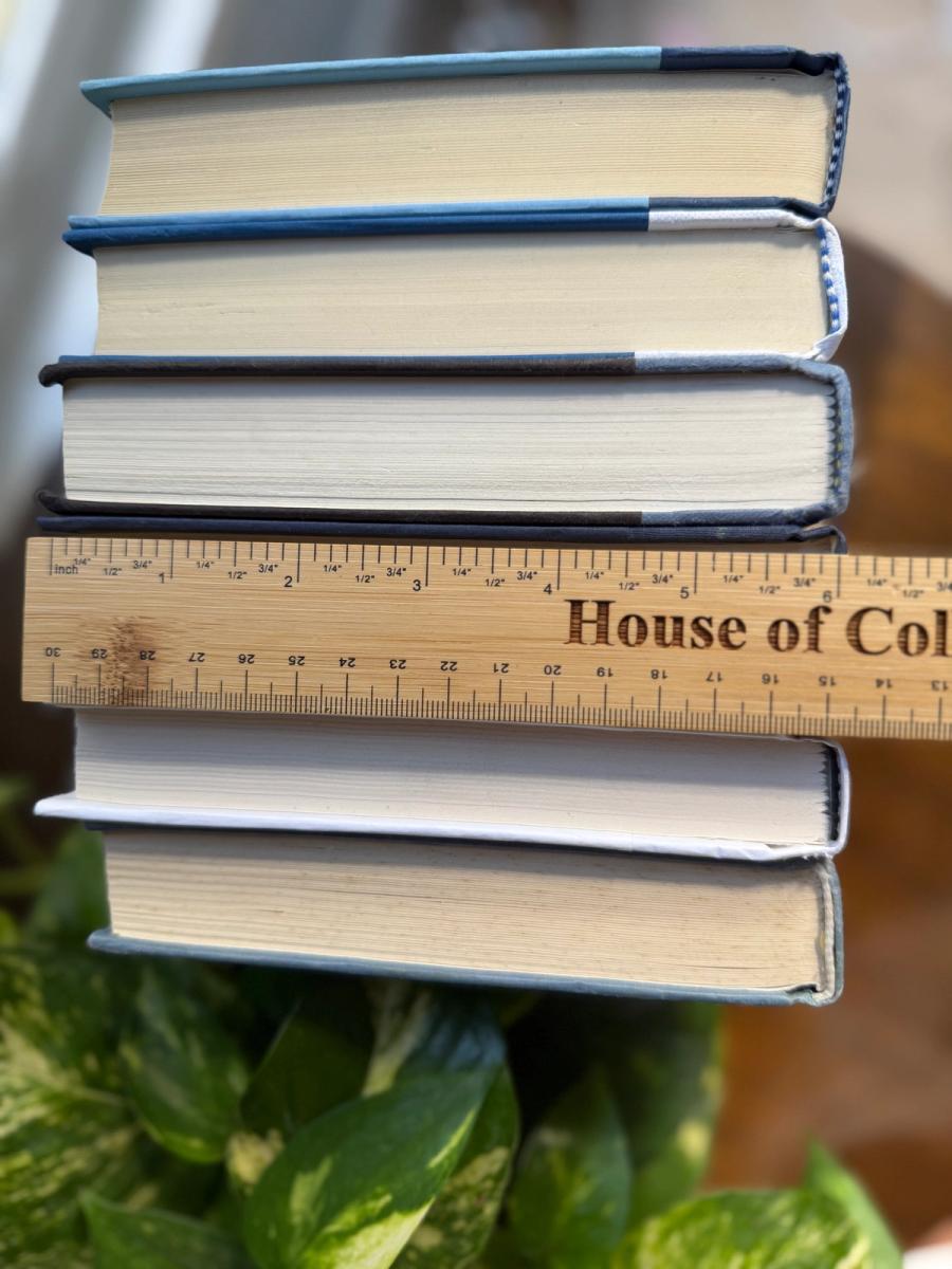 Curated collection of layered blue books ranging from pale coastal blue to deeper ocean tones.
