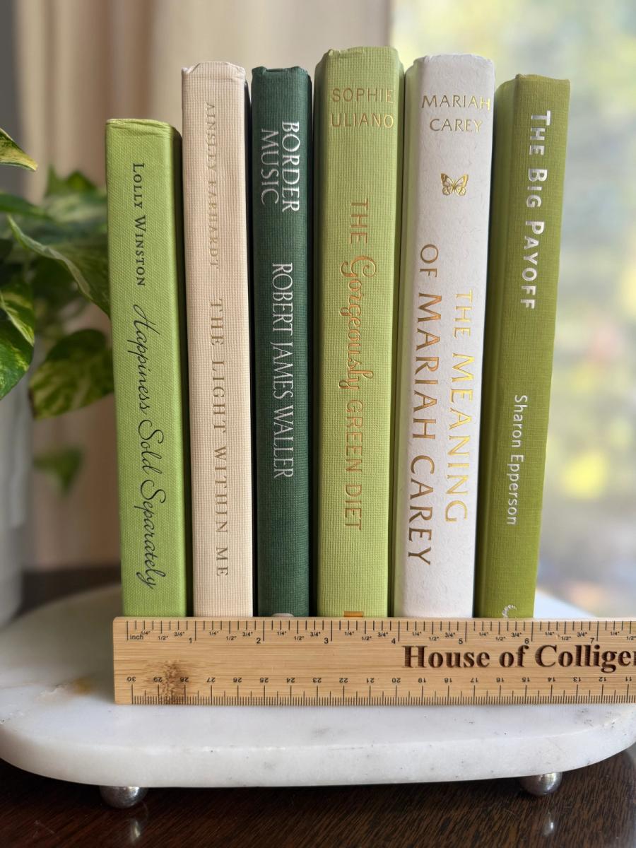 Curated collection of soft sage, olive, cream, and muted green books with botanical tones.