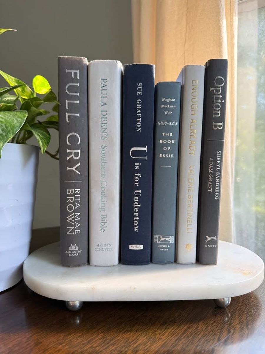 Curated collection of muted blue-gray, slate, charcoal, and softly weathered neutral books.