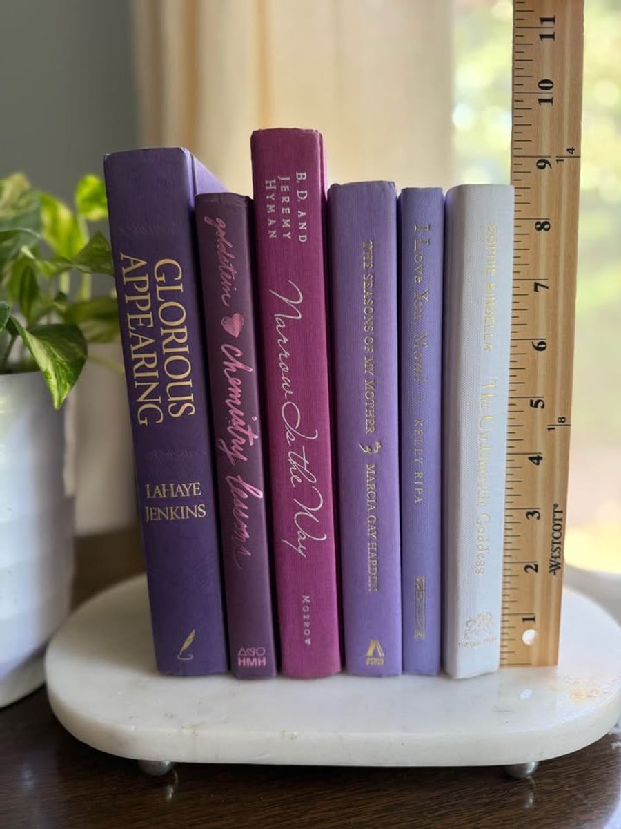 Curated collection of lavender, lilac, orchid, and violet books with soft tonal variation and floral-inspired color.