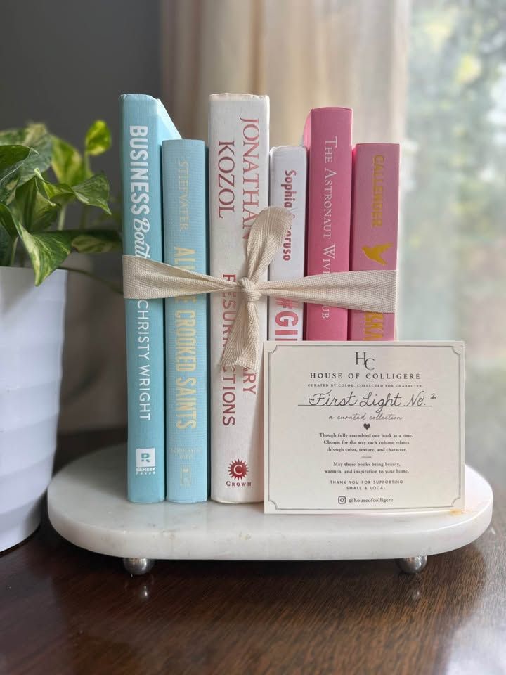 Curated collection of aqua, pale blue, white, and pink books with bright pastel tones and playful contrast.