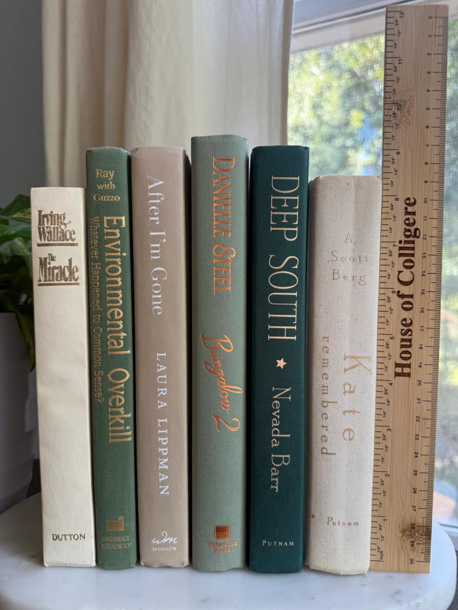 Curated collection of soft sage, olive, cream, and muted green books with botanical tones.