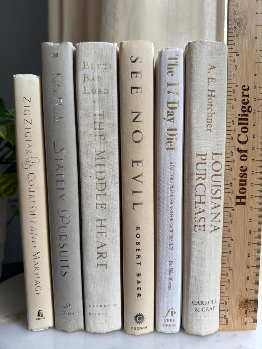 Curated collection of crisp white, ivory, and warm cream books with soft neutral tones.