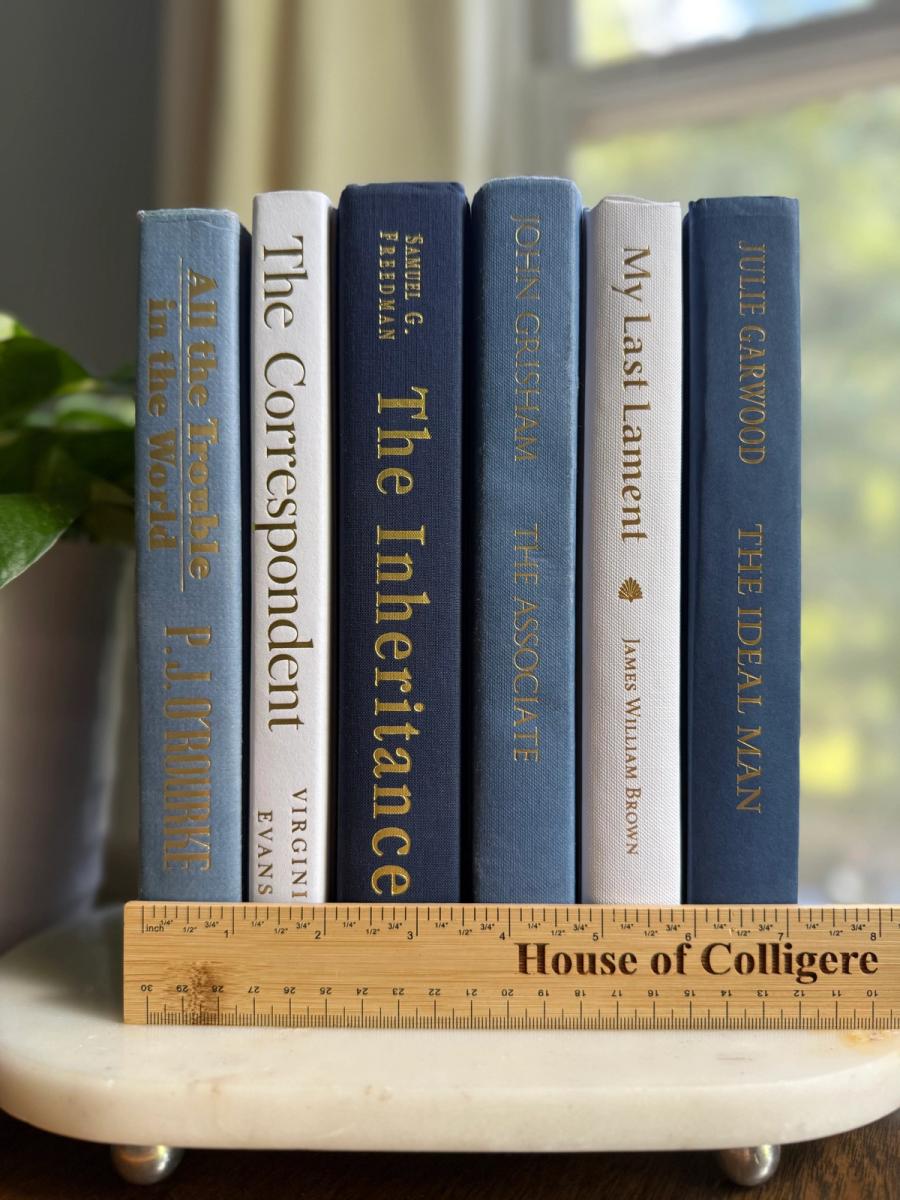 Curated collection of layered blue books ranging from pale coastal blue to deeper ocean tones.