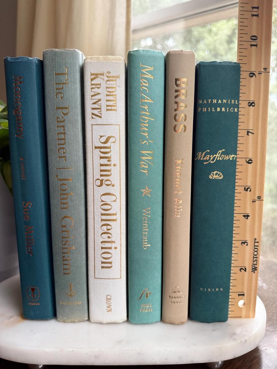 Curated collection of white, pale blue, sand, and soft coastal-neutral books with an airy, sun-faded look.