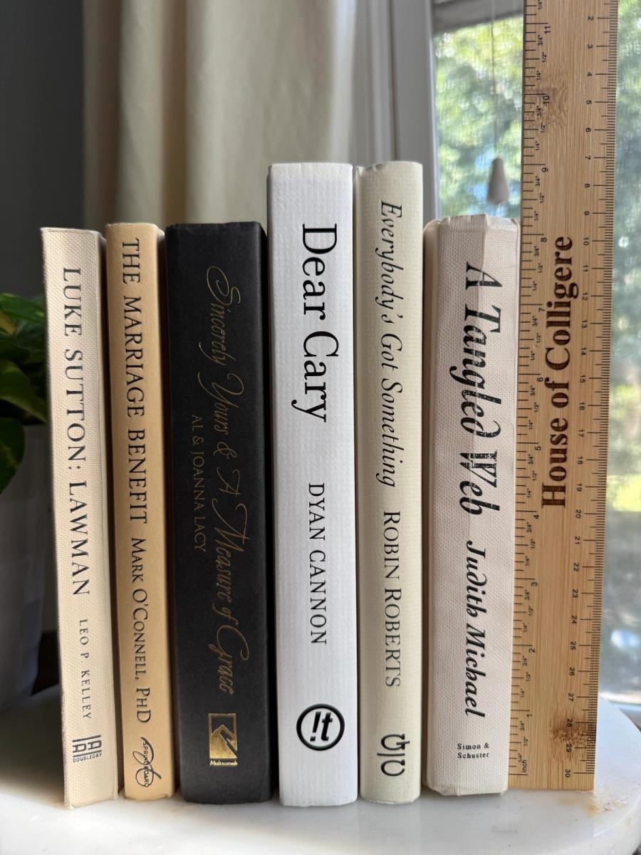 Curated collection of parchment, cream, warm beige, and black books with soft neutral contrast and classic detailing.