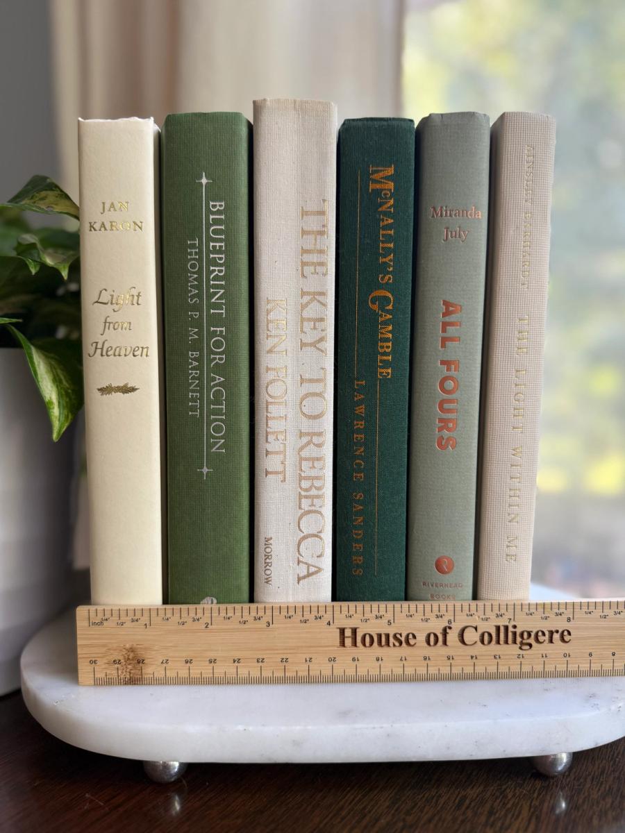 Curated collection of soft sage, olive, cream, and muted green books with botanical tones.