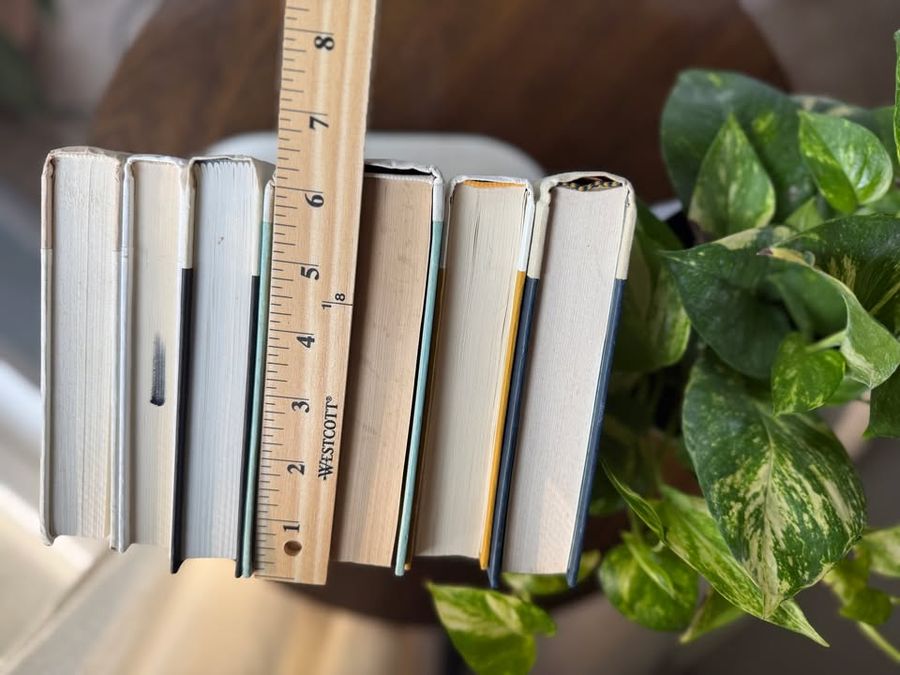 Curated collection of crisp white, ivory, and warm cream books with soft neutral tones.
