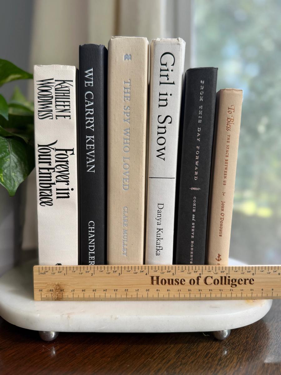 Curated collection of parchment, cream, warm beige, and black books with soft neutral contrast and classic detailing.