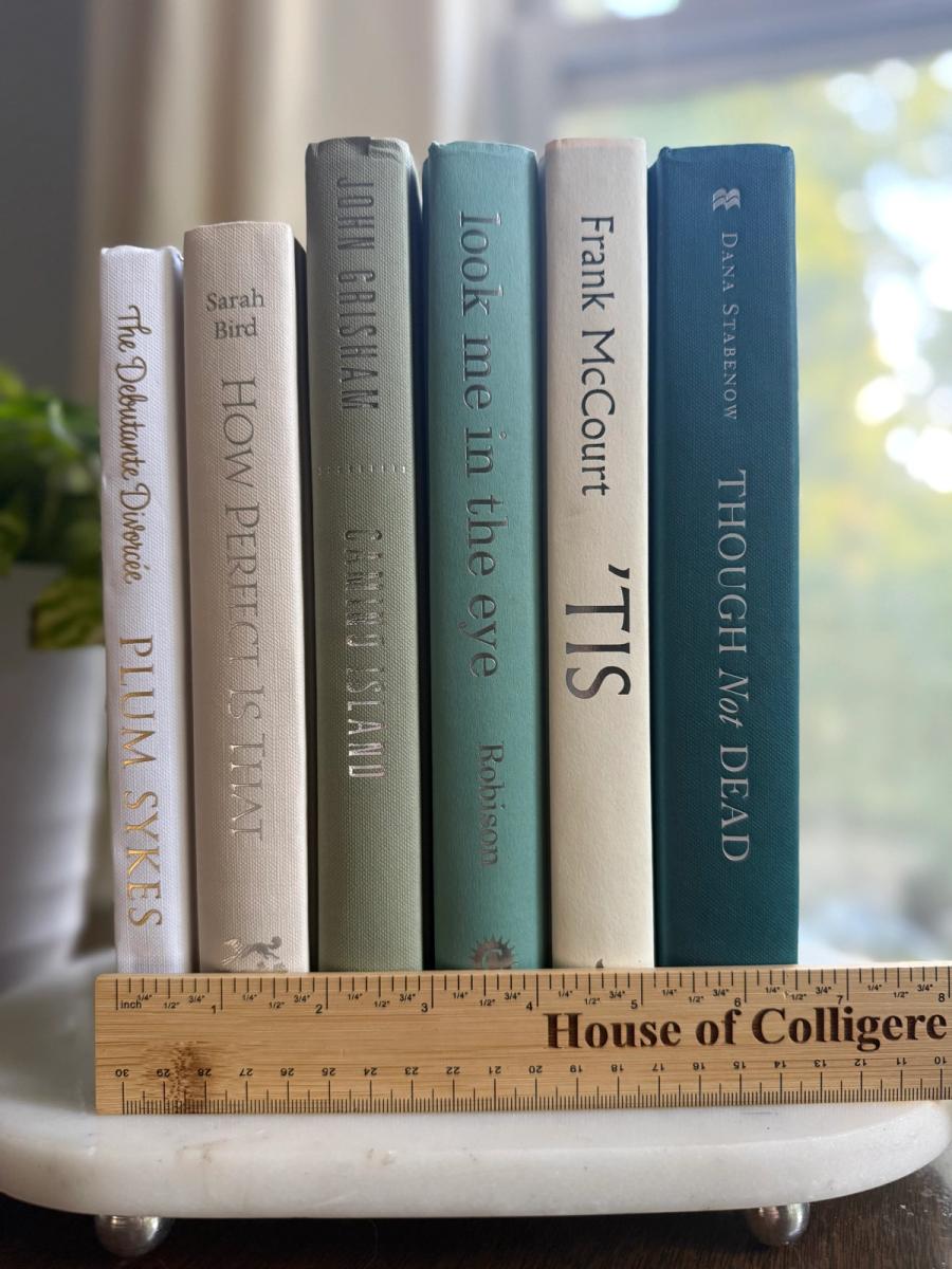 Curated collection of white, pale blue, sand, and soft coastal-neutral books with an airy, sun-faded look.