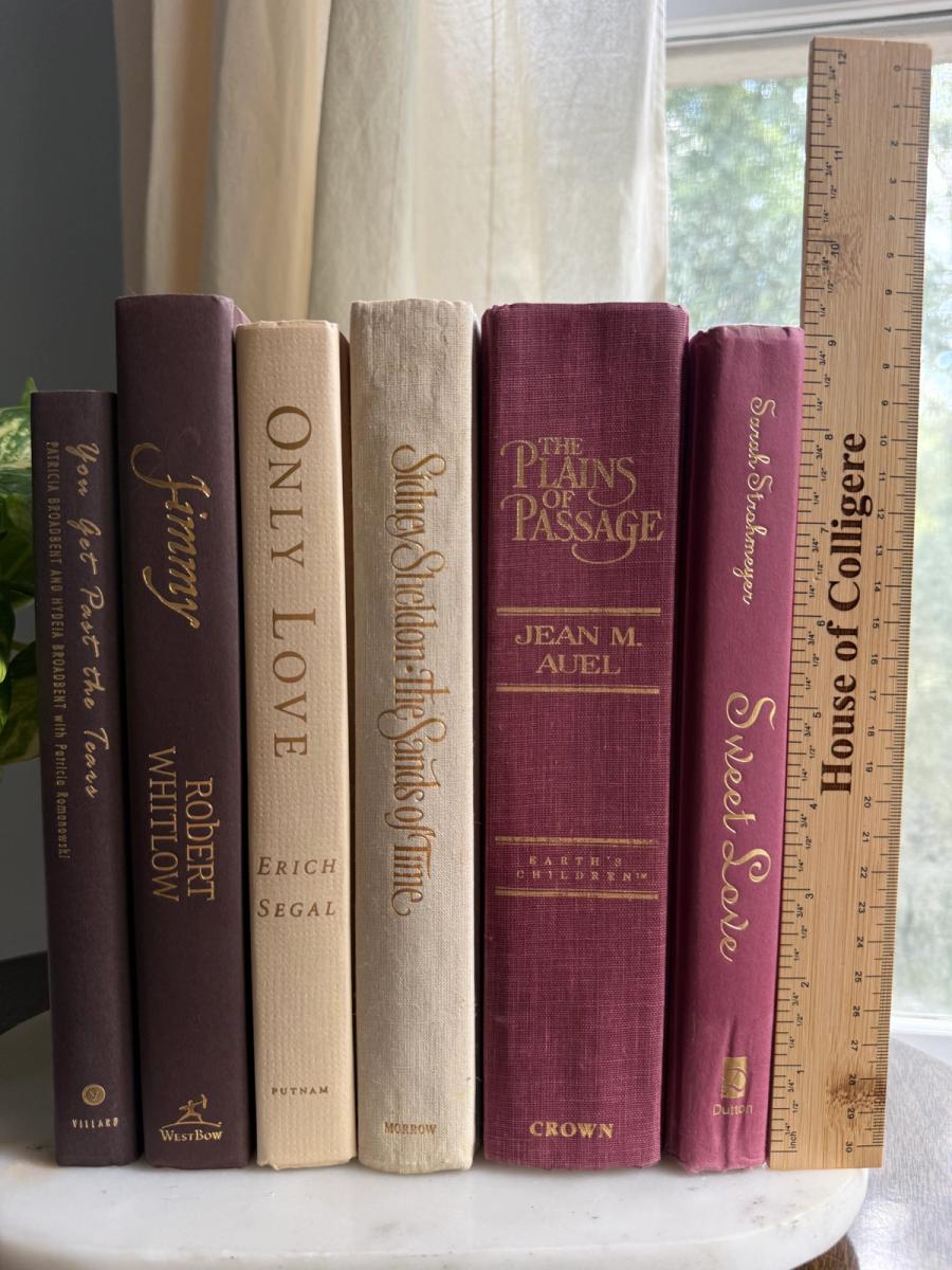 Curated collection of blush, dusty rose, warm taupe, and softly muted neutral books.