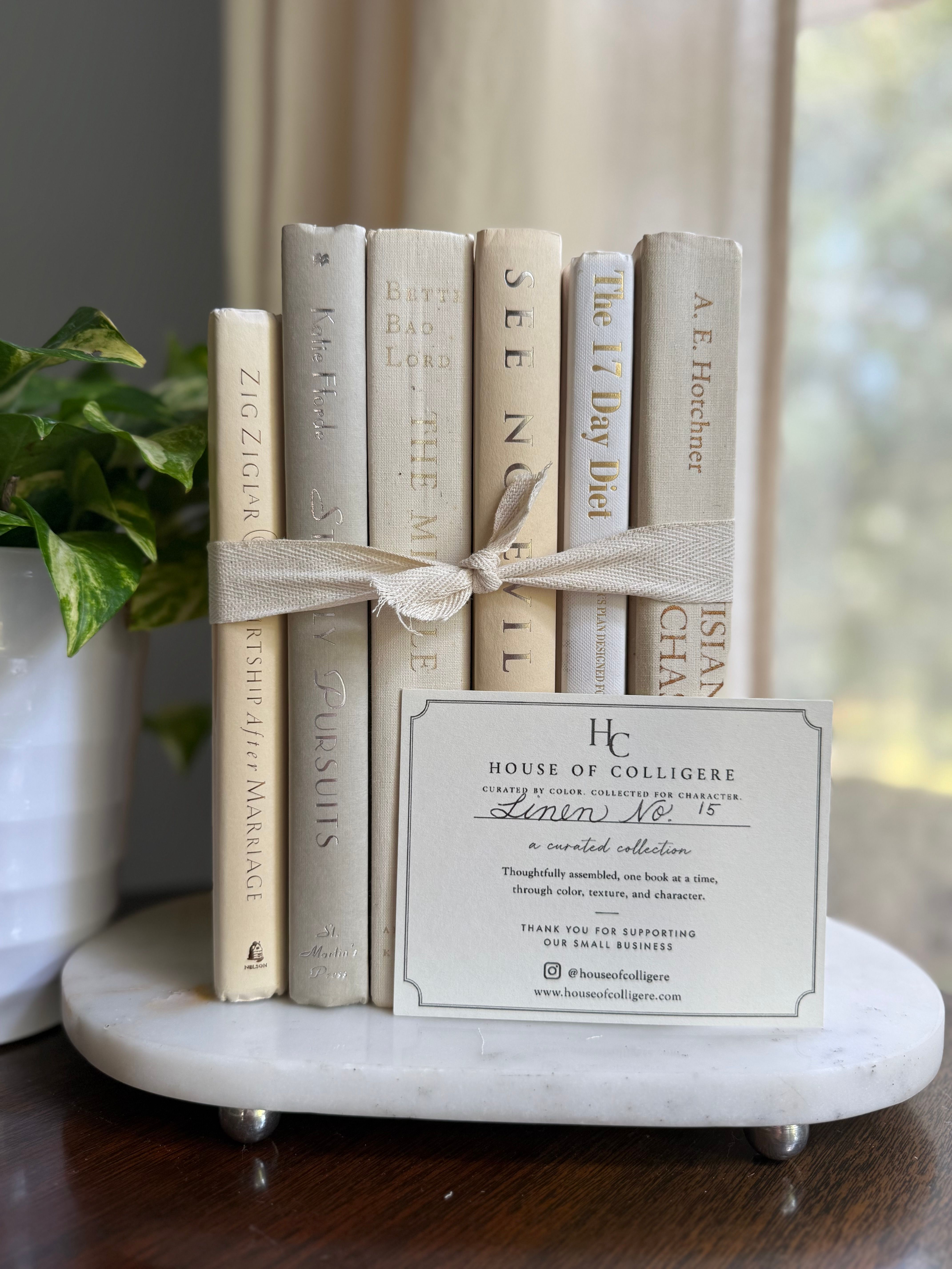 Curated collection of crisp white, ivory, and warm cream books with soft neutral tones.
