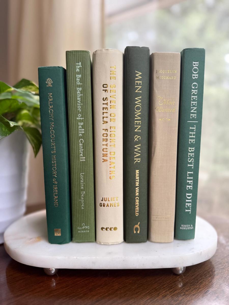 Curated collection of soft sage, olive, cream, and muted green books with botanical tones.
