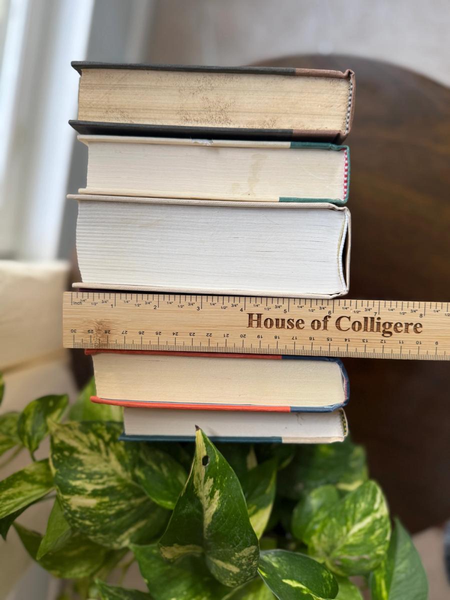 Curated collection of rich brown, hunter green, deep navy, and warm ivory books with classic gold accents.