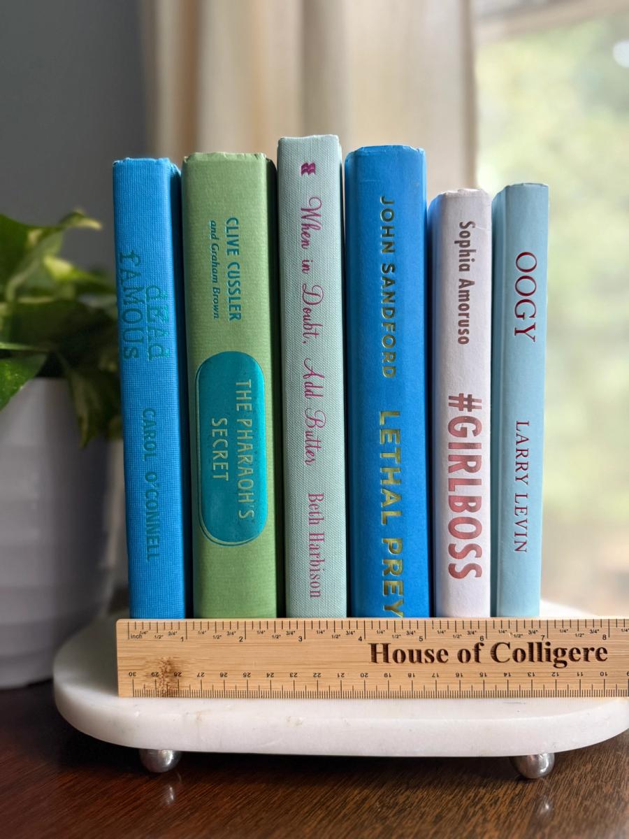 Curated collection of six hardcover books in cobalt blue, sage green, pale aqua, and soft white, tied with natural cotton ribbon and styled beside a House of Colligere collection card.